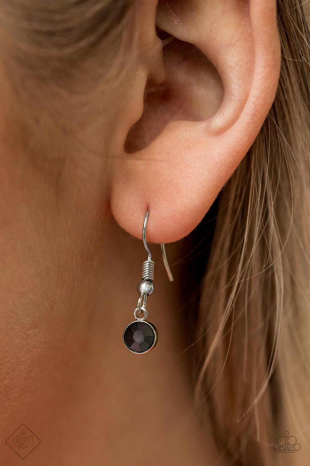Paparazzi Accessories Jaw-Droppingly Jealous - Black Capped in a silver frame radiating with glittery hematite rhinestones, a smoky metallic teardrop pendant swings from the bottom of a dramatically elongated silver chain, creating a jaw-dropping display.