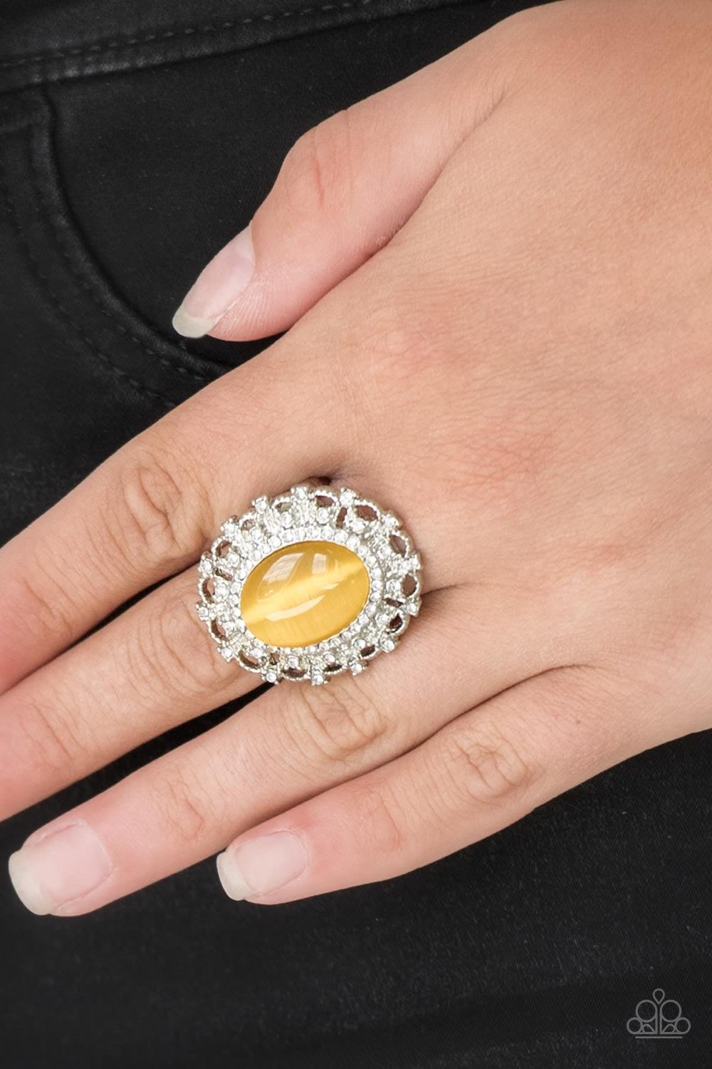 Paparazzi Accessories BAROQUE The Spell - Yellow Encrusted in dainty white rhinestones, a frilly silver frame spins around a glowing yellow moonstone center for a regal look. Features a stretchy band for a flexible fit. Jewelry