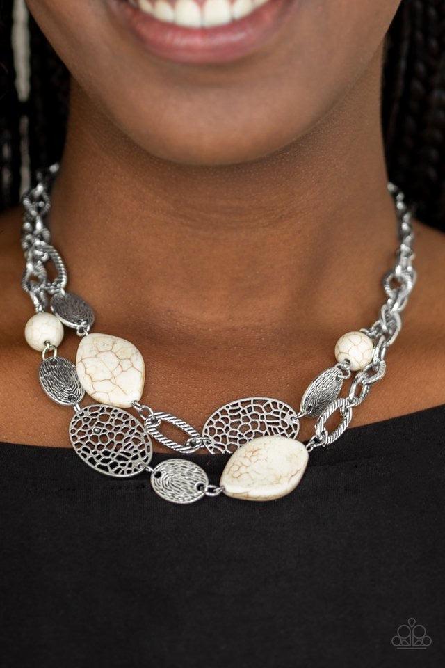 Paparazzi Accessories Second Nature - White Etched in shimmery textures, a chunky silver chain gives way to a collection of refreshing white stones and hammered silver accents. Each featuring patterns derived from nature, the glistening discs join into a