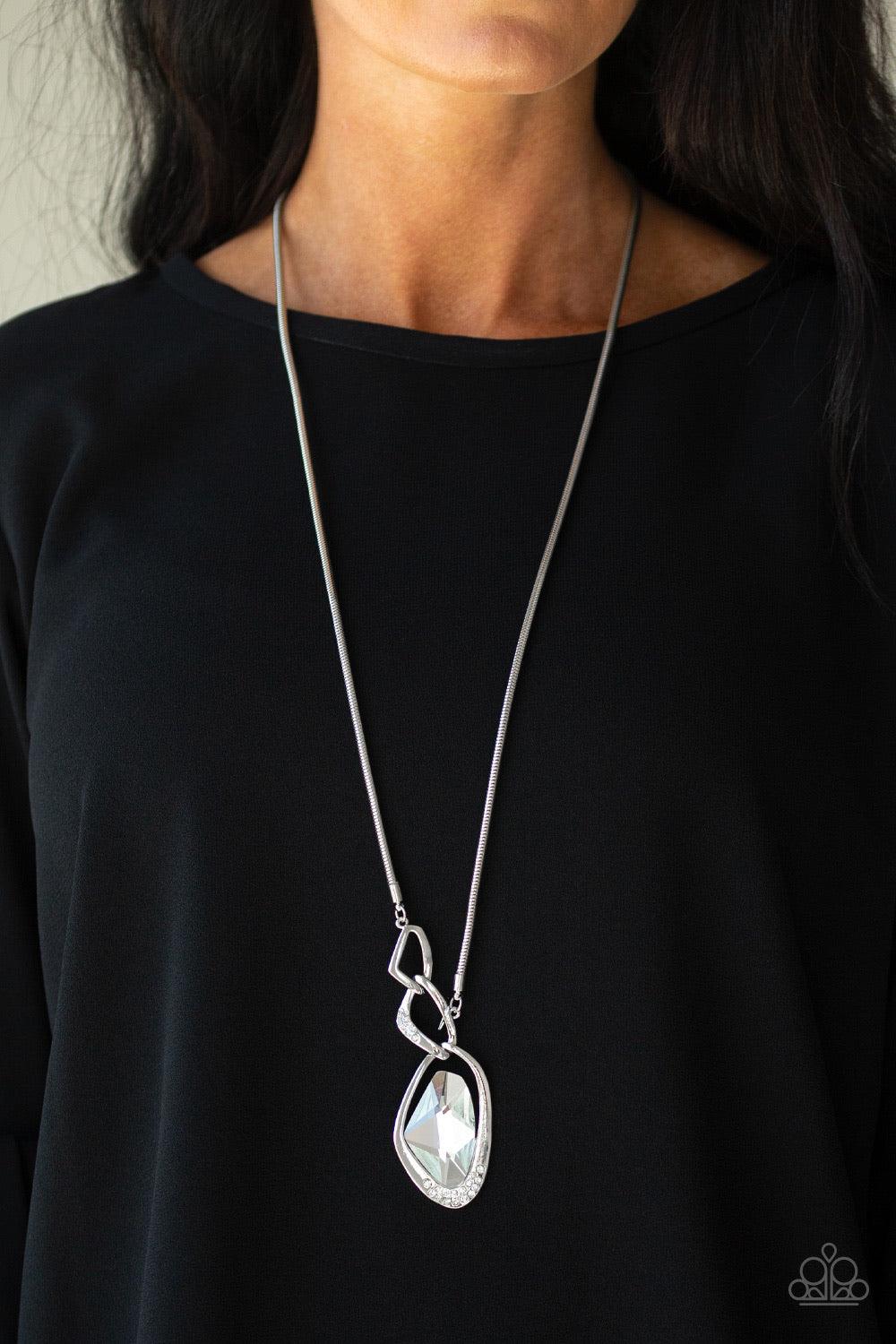 Paparazzi Accessories Optical Opulence - White A faceted white gem is nestled inside of a shimmery silver frame encrusted in dainty white rhinestones. The glittery pendant asymmetrically links with abstract silver frames at the bottom of a lengthened silv