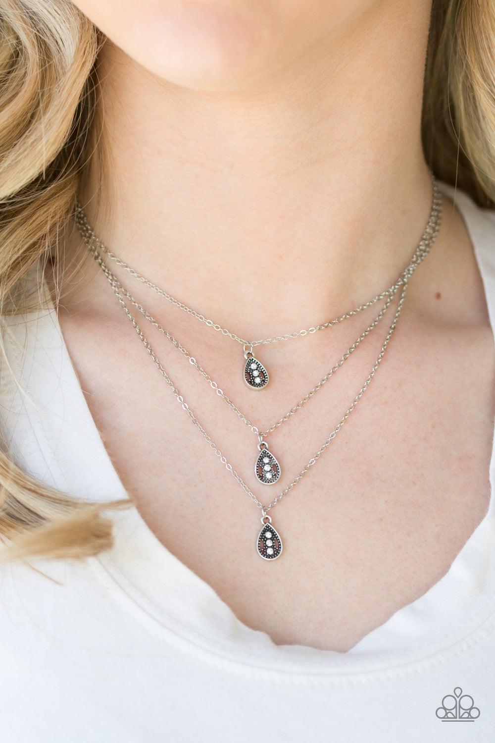 Paparazzi Accessories Radiant Rainfall - White Encrusted in glittery white rhinestones, three shimmery silver teardrops layer below the collar for a whimsical look. Features an adjustable clasp closure. Sold as one individual necklace. Includes one pair o