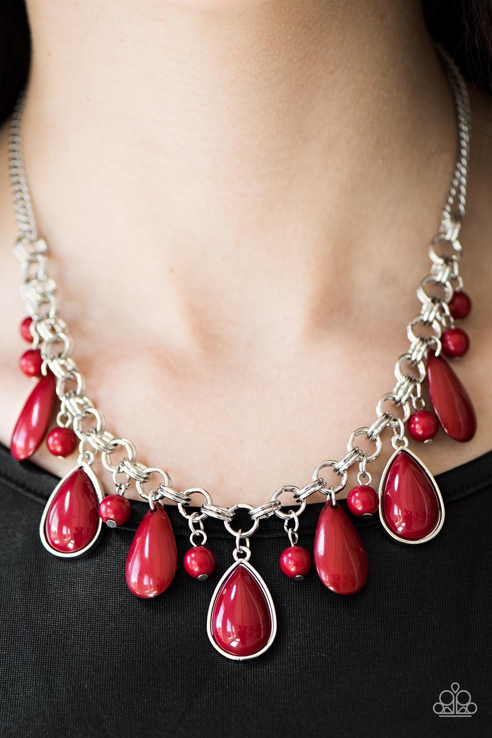 Paparazzi Accessories This Side of Malibu - Red Polished red beads and teardrops cascade from the bottom of a dramatic silver chain. Three red teardrops are pressed into sleek silver frames, catching and reflecting the light as the flirty fringe falls jus