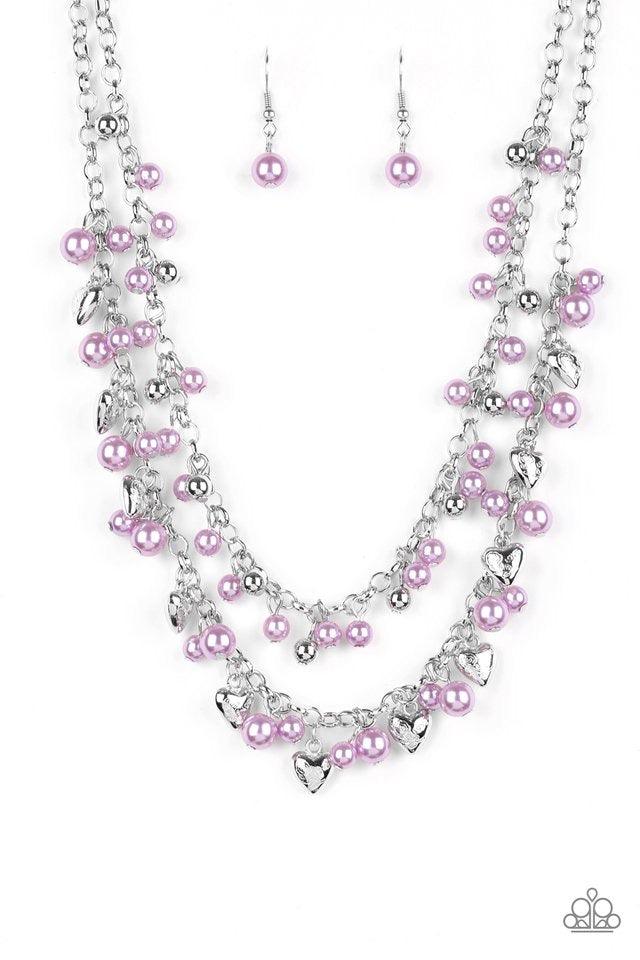 Paparazzi Accessories Kindhearted Heart - Purple A collection of shiny silver beads and pearly purple beads cascade from the bottoms of two layered silver chains. Stamped in the word, "Love" floral heart charms dangle from the lowermost chain, creating a