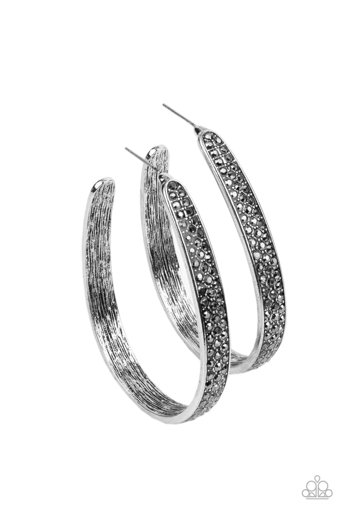Paparazzi Accessories Bossy and Glossy - Silver Row after row of smoky hematite rhinestones are encrusted across the front of a textured silver hoop, creating a smoldering centerpiece. Earring attaches to a standard post fitting. Hoop measures approximate