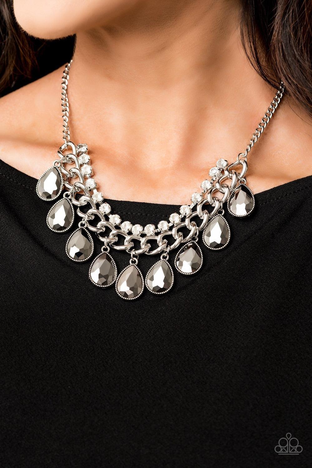 Paparazzi Accessories All Toget-HEIR Now - Silver Teardrop hematite rhinestones swing from the bottom of a bold silver chain, creating a dramatic fringe below the collar. A strand of glittery white rhinestones attach to the top of a shimmery silver chain,