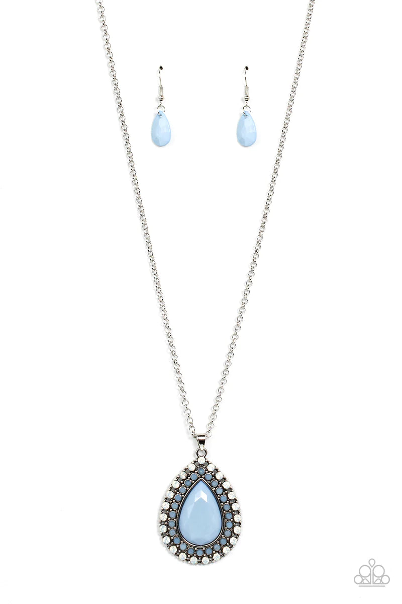 Paparazzi Accessories DROPLET Like It’s Hot - Blue A faceted blue teardrop is pressed into the center of a silver frame bordered in rows of opalescent white and blue beads, creating an ethereal pendant at the bottom of a classic silver chain. Features an