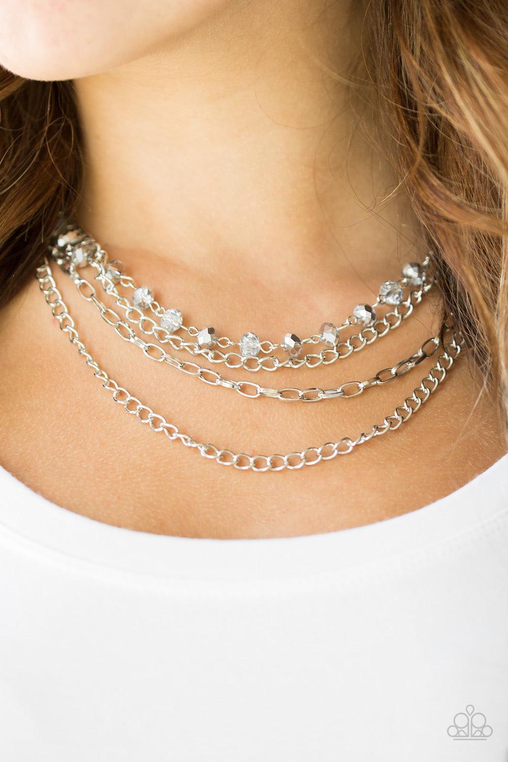 Paparazzi Accessories Extravagant Elegance - Silver Mismatched silver chains layer down the chest. A strand of faceted smoky and metallic gems join below the collar for a glamorous look. Features an adjustable clasp closure. Sold as one individual necklac