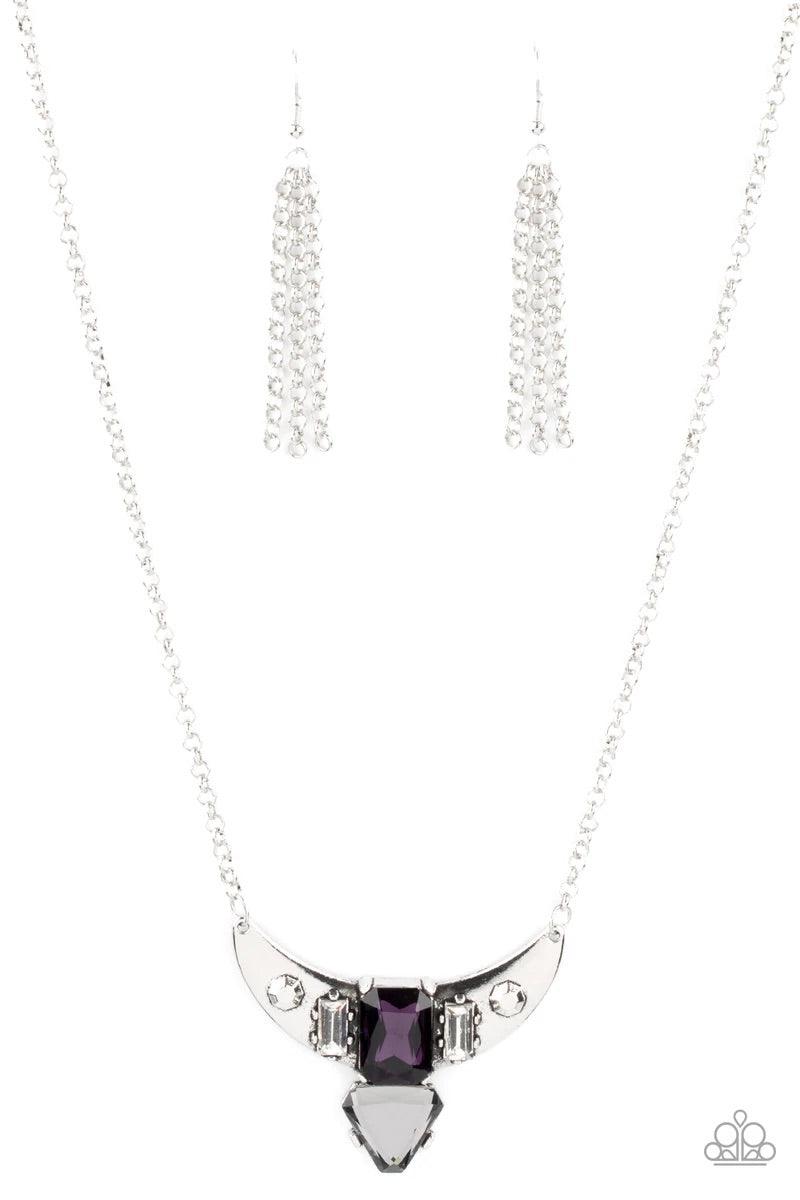 Paparazzi Accessories You the TALISMAN! - Purple Pairs of faceted silver beads and glassy white emerald cut gems flank an oversized emerald cut purple gem atop an antiqued silver half moon frame. A smoky triangular cut gem adorns the bottom of the pendant
