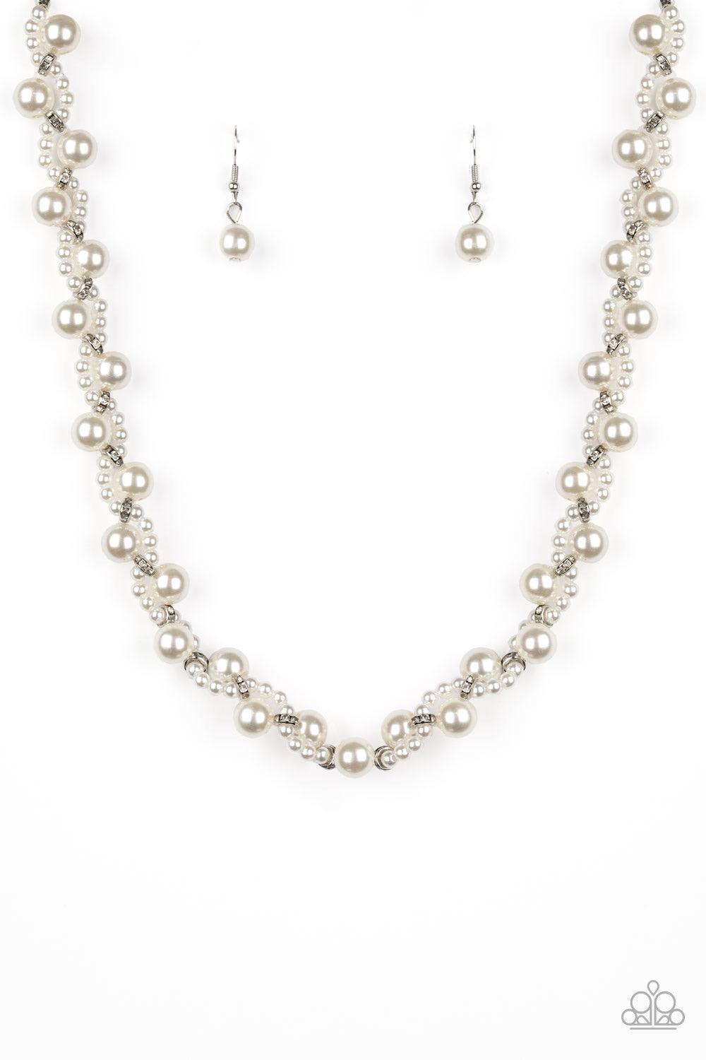 Paparazzi Accessories Uptown Opulence ~White Threaded along invisible wires, a strand of classic white pearls delicately weaves with a strand of dainty white pearls and white rhinestone encrusted rings below the collar for a timeless twist. Features an ad