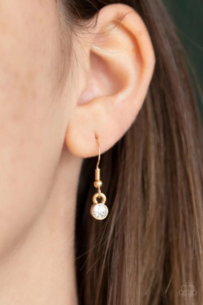 Paparazzi Accessories Time Square Stunner - Gold Encrusted in glittery white rhinestones, two gold square frames link at the bottom of a lengthened gold box chain. Flattened gold chains stream from the bottom of the stacked pendant, creating an edgy tasse