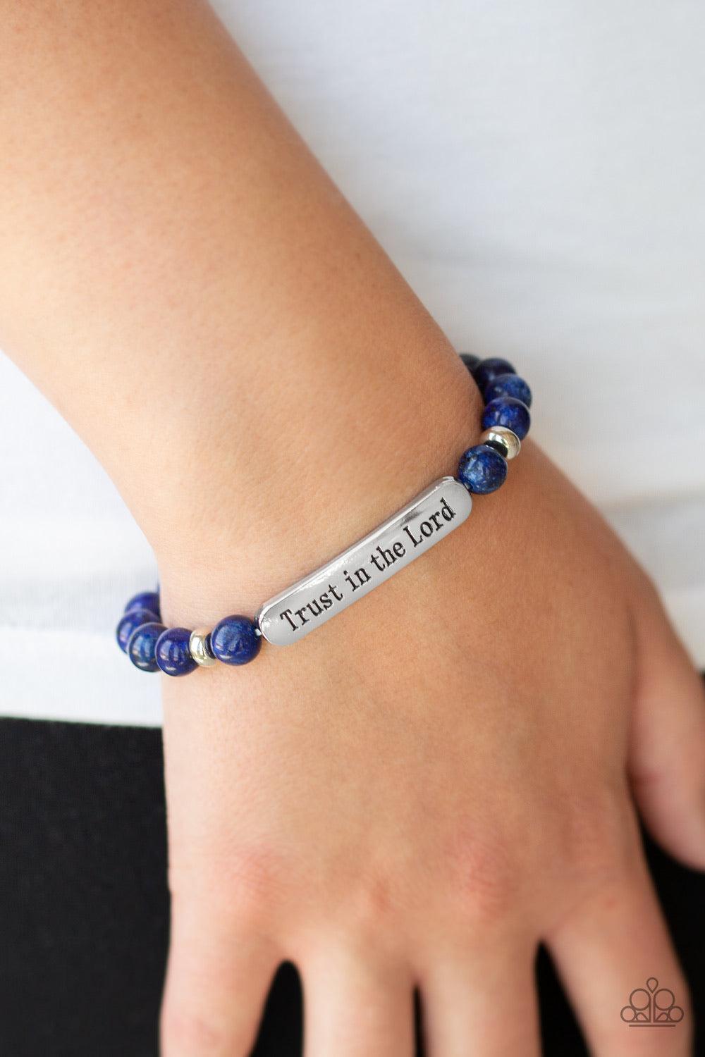 Paparazzi Accessories Trust Always - Blue Infused with dainty silver accents, a collection of glassy blue stone beads and a shimmery silver frame stamped in the phrase, "Trust in the Lord", are threaded along a stretchy band around the wrist for an inspir
