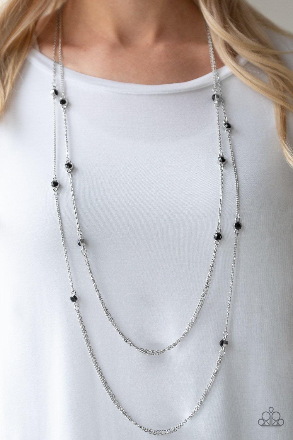 Paparazzi Accessories Sparkle of the Day - Black Dotted with glittery black rhinestones, two glistening silver chains give way to layers of dainty silver chain for a refined look. Features an adjustable clasp closure.Sold as one individual necklace. Inclu