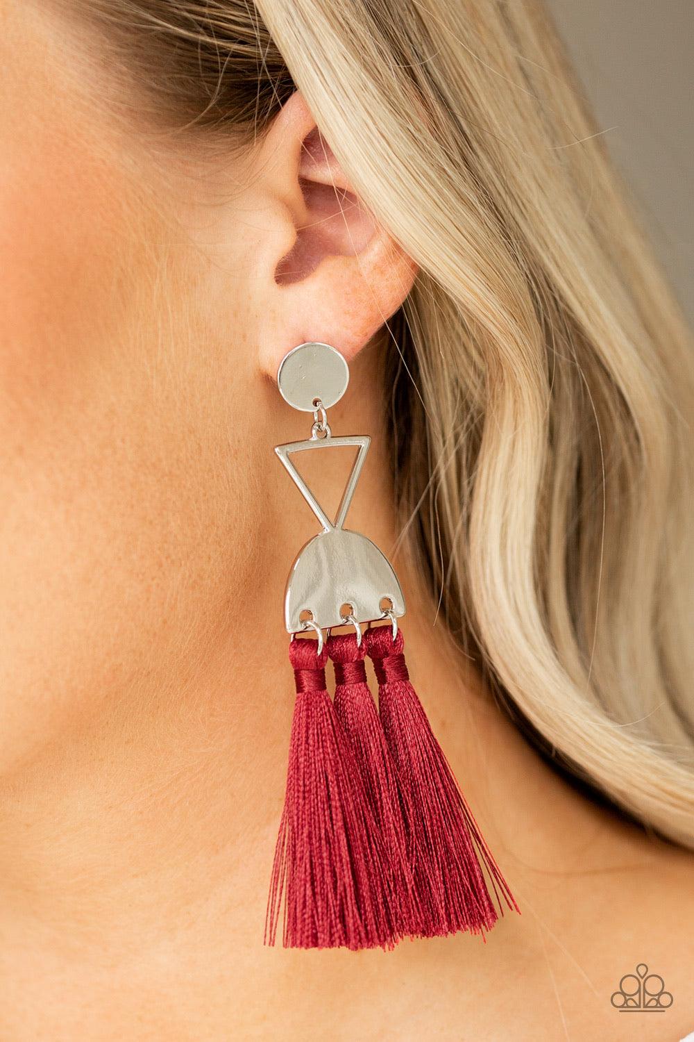 Paparazzi Accessories Tassel Trippin - Red A shimmery silver disc, airy silver triangle, and shimmery half moon frame link into a geometric lure. Three red threaded tassels swing from the bottom of the stacked frame for a trendy finish. Earring attaches t