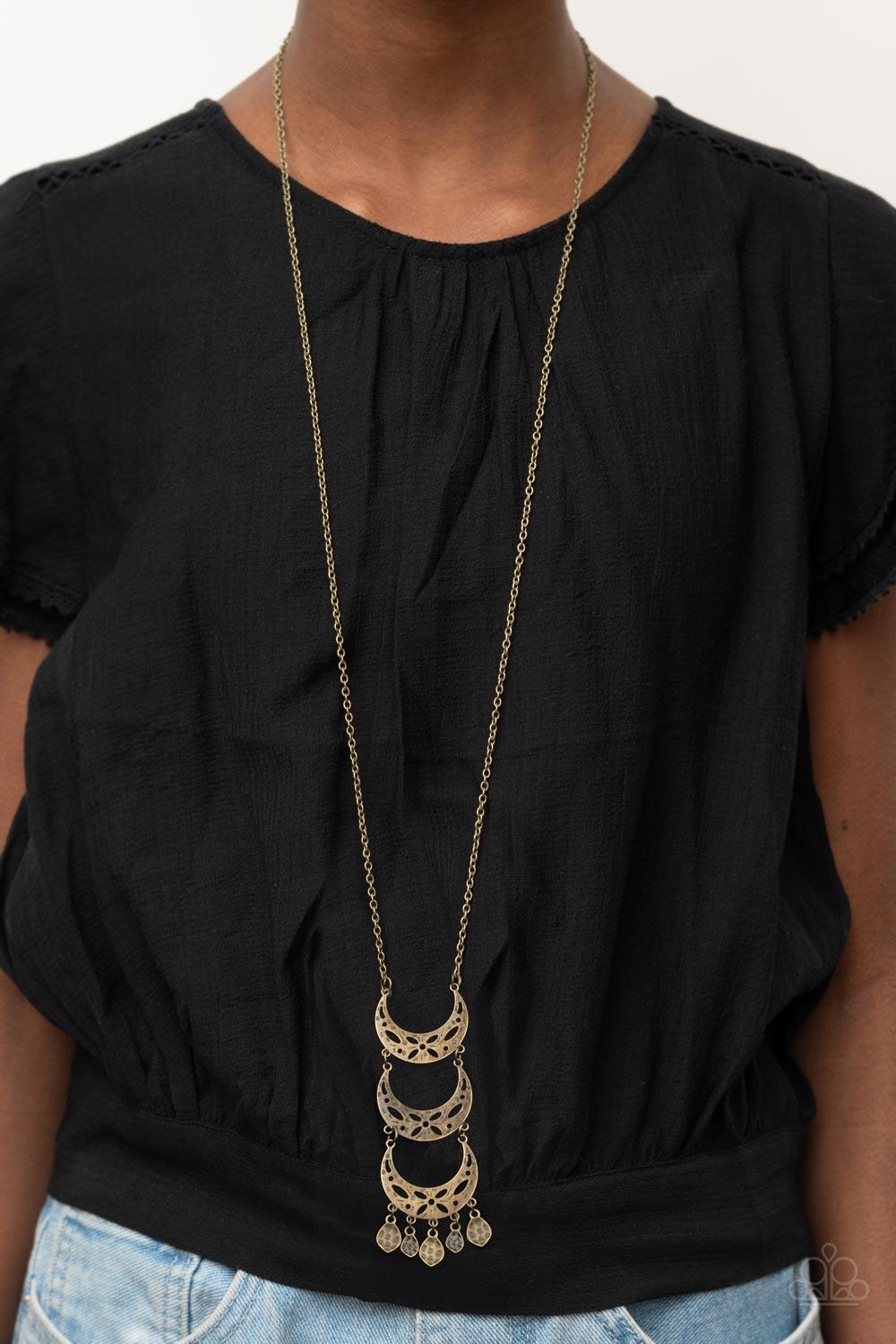 Paparazzi Accessories Half-Moon Child - Brass Stenciled in airy floral details, antiqued brass half-moon frames link into a triple stacked pendant at the bottom of a lengthened brass chain. Hammered brass frames trickle from the bottom, adding playful mov