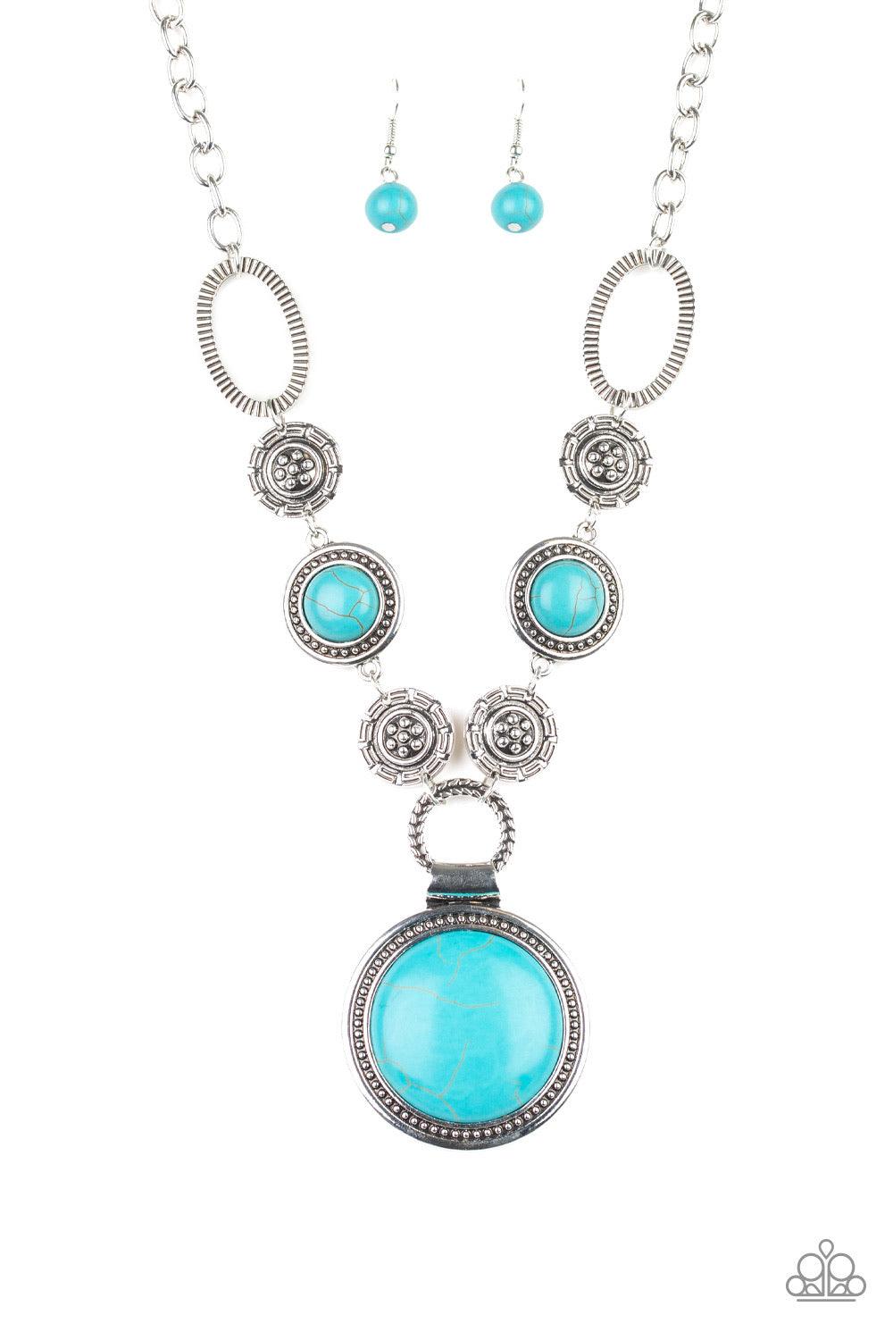 Paparazzi Accessories Sedona Drama ~Blue Featuring floral, textured, and refreshing turquoise stone accents, a collection of unique silver frames link below the collar for a seasonal flair. A dramatically oversized turquoise stone pendant dangles from the