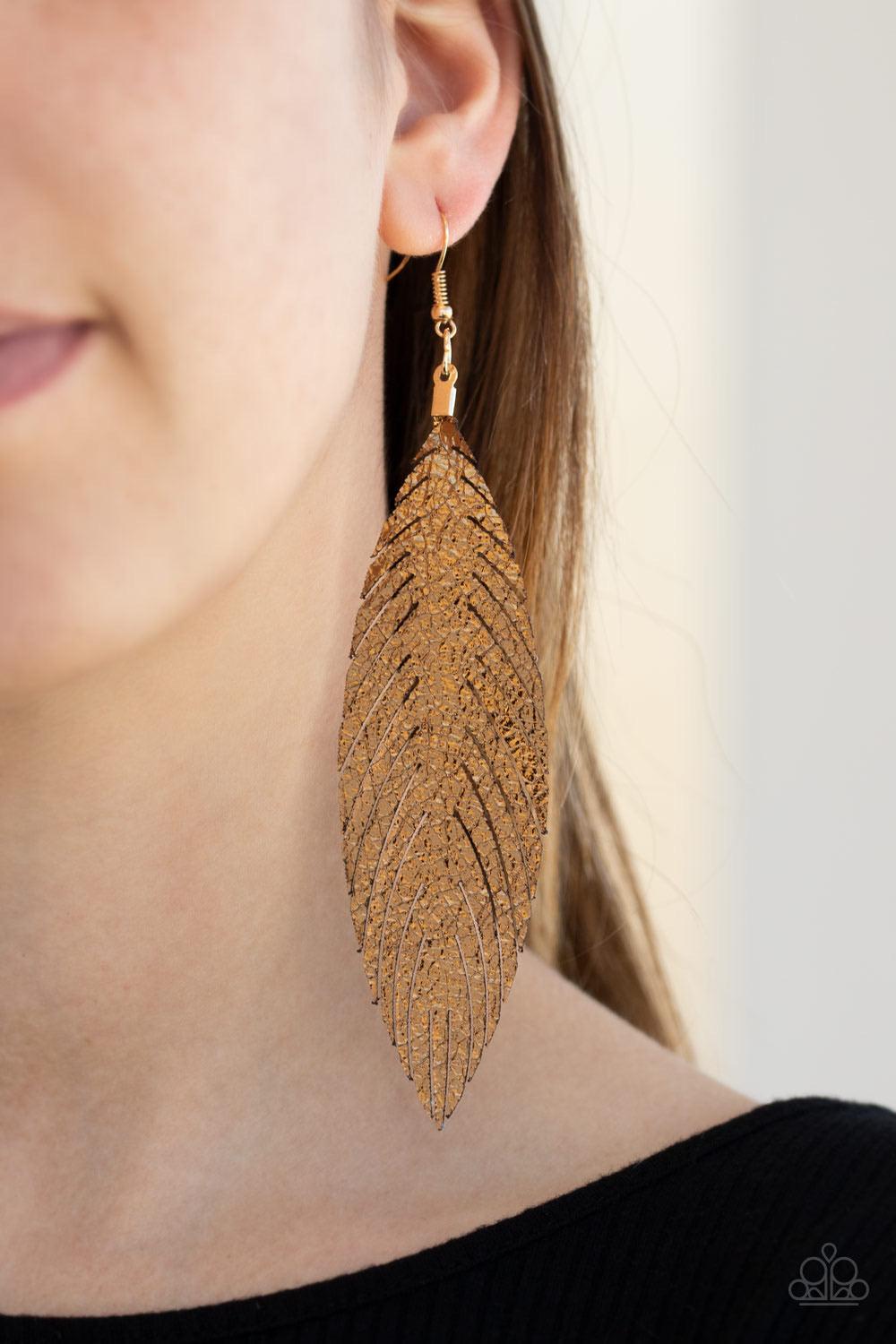 Paparazzi Accessories Feather Fantasy - Gold Brushed in a golden metallic finish, a flat leather feather frame swings from the ear for a statement-making finish. Earring attaches to a standard fishhook fitting. Sold as one pair of earrings. Jewelry