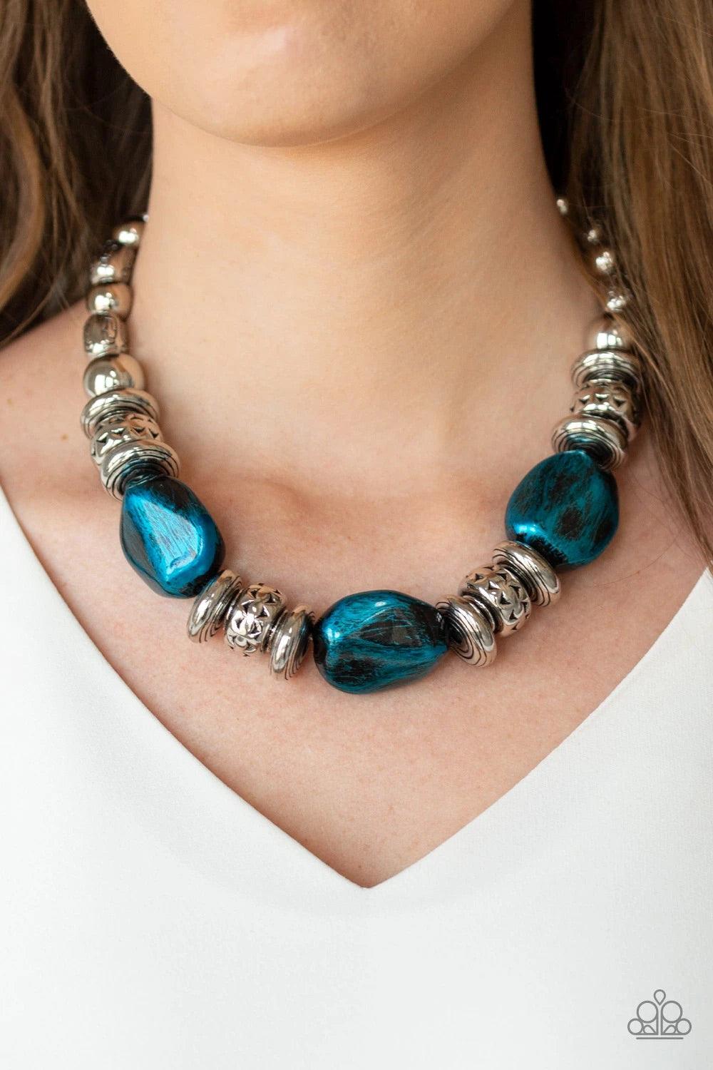 Paparazzi Accessories Colorfully Confident - Blue A collection of classic silver beads, ornate silver accents, and metallic blue faux rock beads are threaded along an invisible wire below the collar for a statement-making finish. Features an adjustable cl