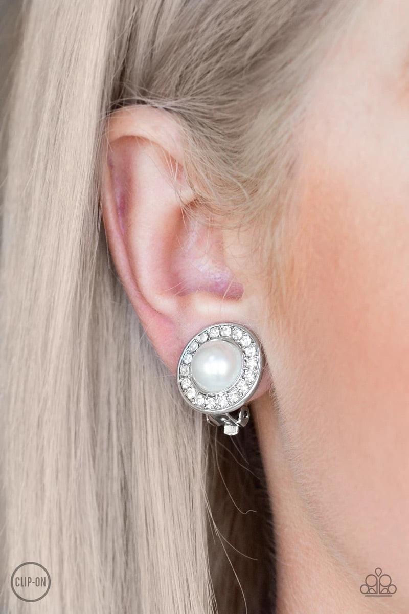Paparazzi Accessories Definitely Dapper - White *Clip-On A ring of glassy white rhinestones spins around a white pearl-drop center for a timeless look. Earring attaches to a standard clip-on fitting. Sold as one pair of clip-on earrings. Jewelry