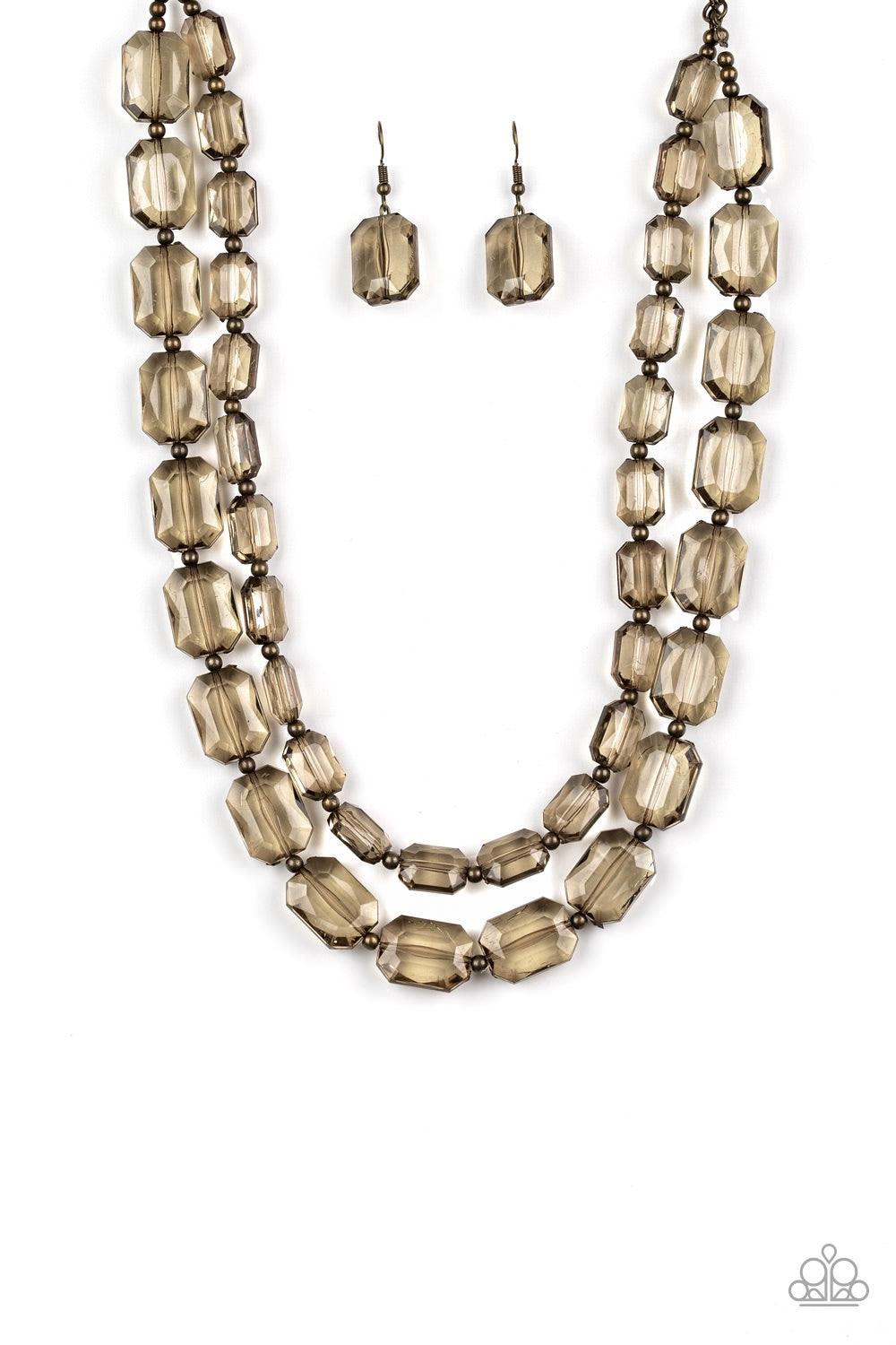 Paparazzi Accessories Ice Bank - Brass Infused with dainty brass beads, glassy emerald-cut beads layer below the collar for an edgy look. Features an adjustable clasp closure. Jewelry