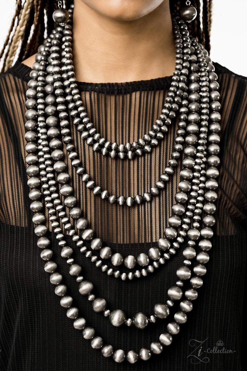 Paparazzi Accessories Instinct 💗ZiCollection $25💗 Strung between two silver fittings, row after row of hypnotizing gunmetal cat's eye beads cascade down the chest. The mesmerizing strands vary in size and pattern, creating haphazard layers of spellbindi