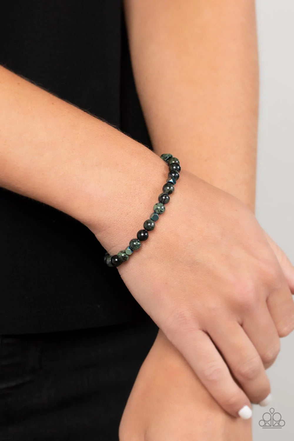 Paparazzi Accessories Interstellar Solitude - Green A dainty collection of speckled green stone beads and faceted metallic cube beads are threaded along a stretchy band around the wrist for an earthy flair. Sold as one individual bracelet. Jewelry