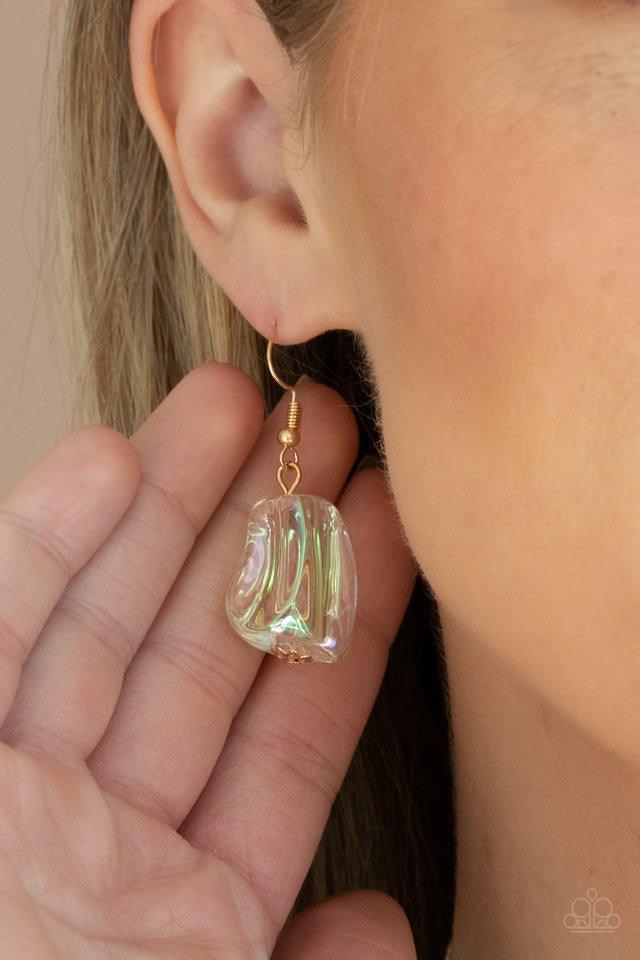 Paparazzi Accessories Iridescently Ice Queen - Gold Featuring an icy iridescence, glassy asymmetrical beads joins a mismatched collection of gold beads, white rhinestone encrusted rings, and scalloped gold accents below the collar. Attached to a gold chai