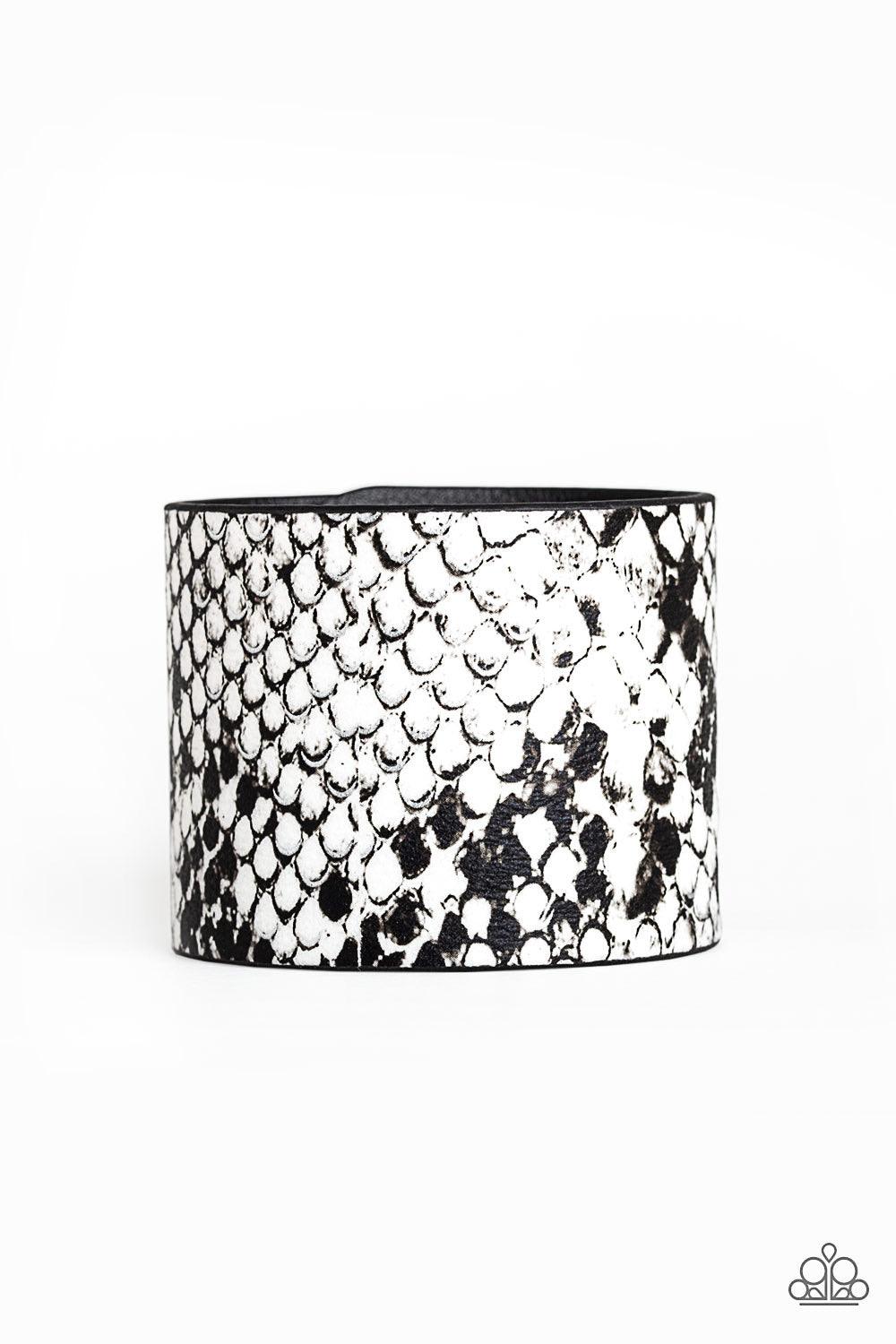 Paparazzi Accessories What’s HISS Is Mine ~White Featuring black and white python print, a thick black leather band wraps around the wrist for a wild look. Features an adjustable snap closure.