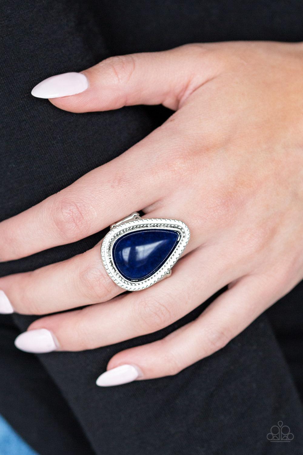 Paparazzi Accessories Mojave Mist - Blue Chiseled into a tranquil teardrop, a depthless blue stone is pressed into a textured silver teardrop frame for a seasonal look. As the stone elements in this piece are natural, some color variation is normal. Featu