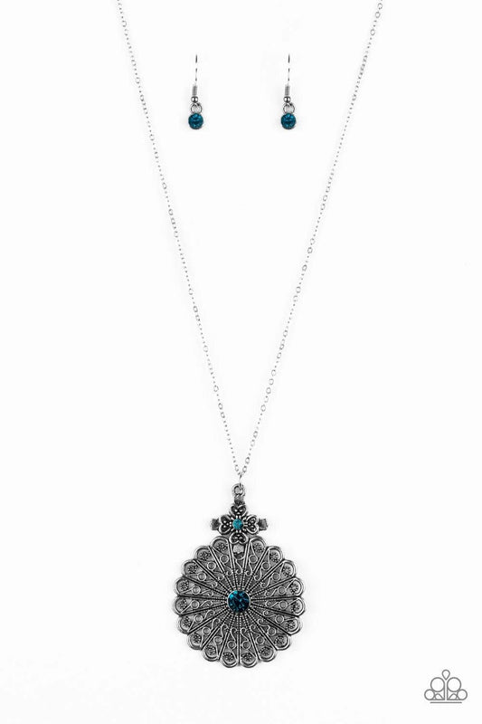 Paparazzi Accessories Walk On The WILDFLOWER Side - Blue Filigree filled petals flare from a glittery blue rhinestone center, creating a whimsical floral pendant at the bottom of a lengthened silver chain. Features an adjustable clasp closure. Sold as one