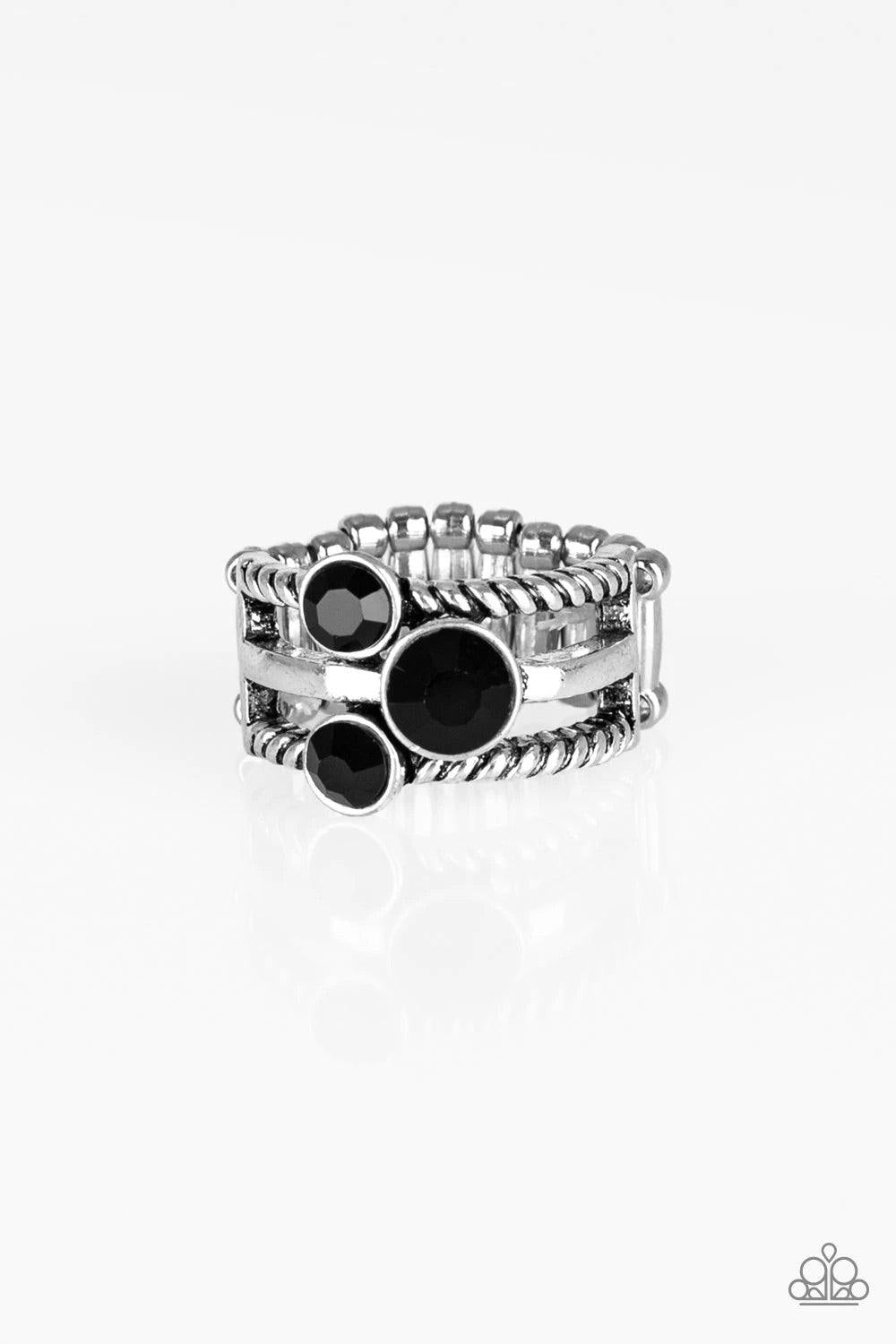 Paparazzi Accessories Head in The Stars - Black A trio of glittery black rhinestones are sprinkled along smooth and twisted silver bands, creating edgy layers across the finger. Features a stretchy band for a flexible fit. Rings