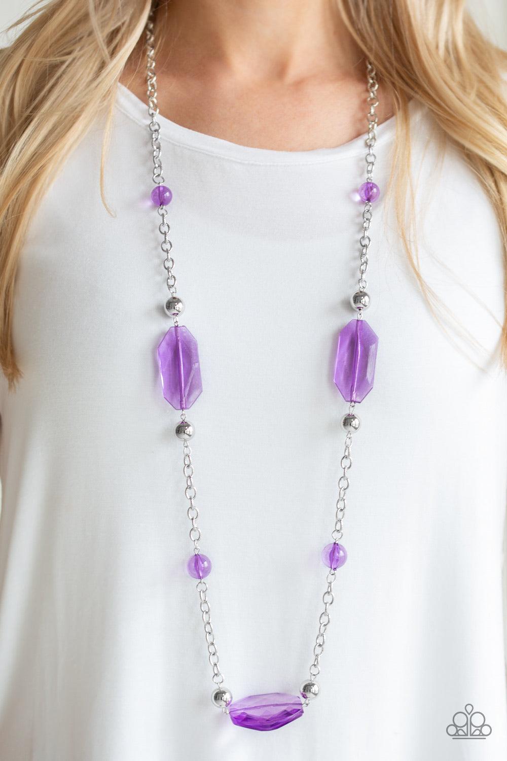 Paparazzi Accessories Crystal Charm - Purple A collection of glassy purple beads, shiny silver beads, and oversized faceted crystal-like beads trickle along a shimmery silver chain across the chest for a whimsically refined look. Features an adjustable cl