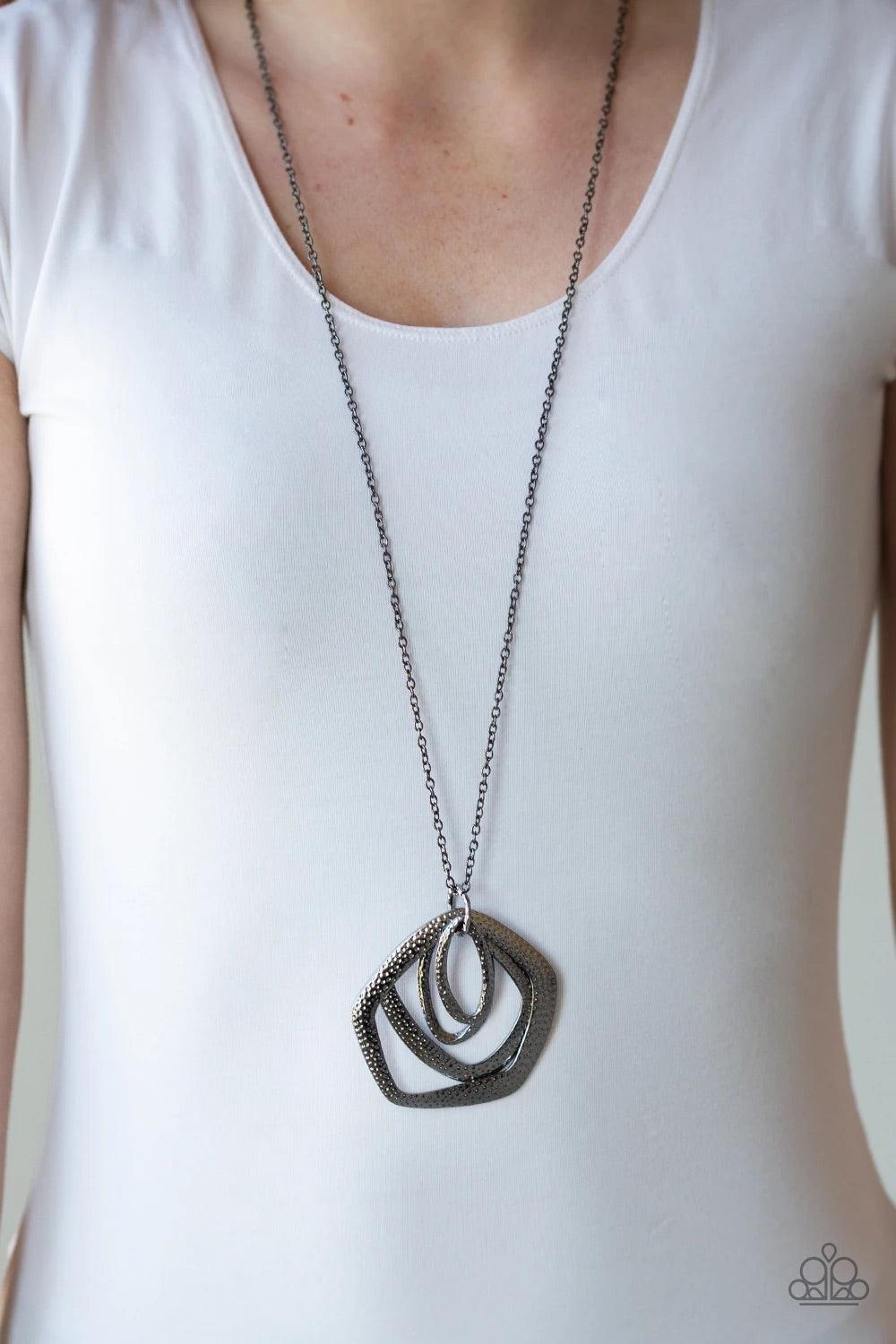 Paparazzi Accessories Urban Artisan ~Black A collection of hammered geometric frames swing from the bottom of a lengthened gunmetal chain, creating a bold artisan inspired pendant. Features an adjustable clasp closure. Sold as one individual necklace. Inc