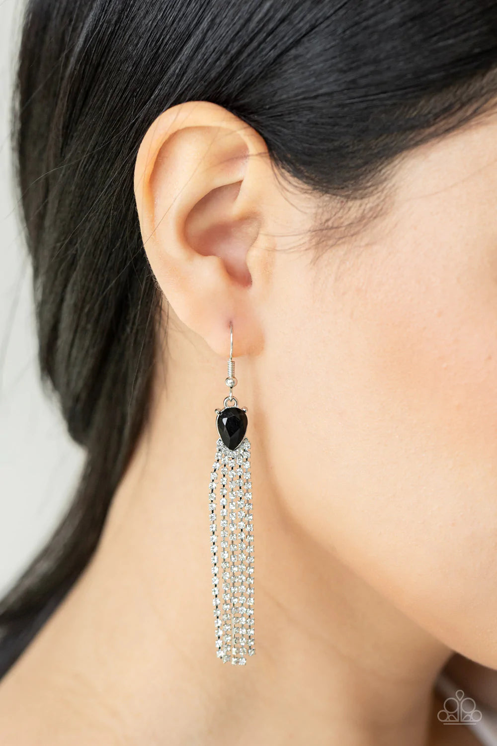 Paparazzi Accessories Drop-Dead Dainty - Black Dainty strands of glassy white rhinestones stream out from the bottom of a glittery black teardrop rhinestone, creating a timelessly tasseled display. Earring attaches to a standard fishhook fitting. Sold as
