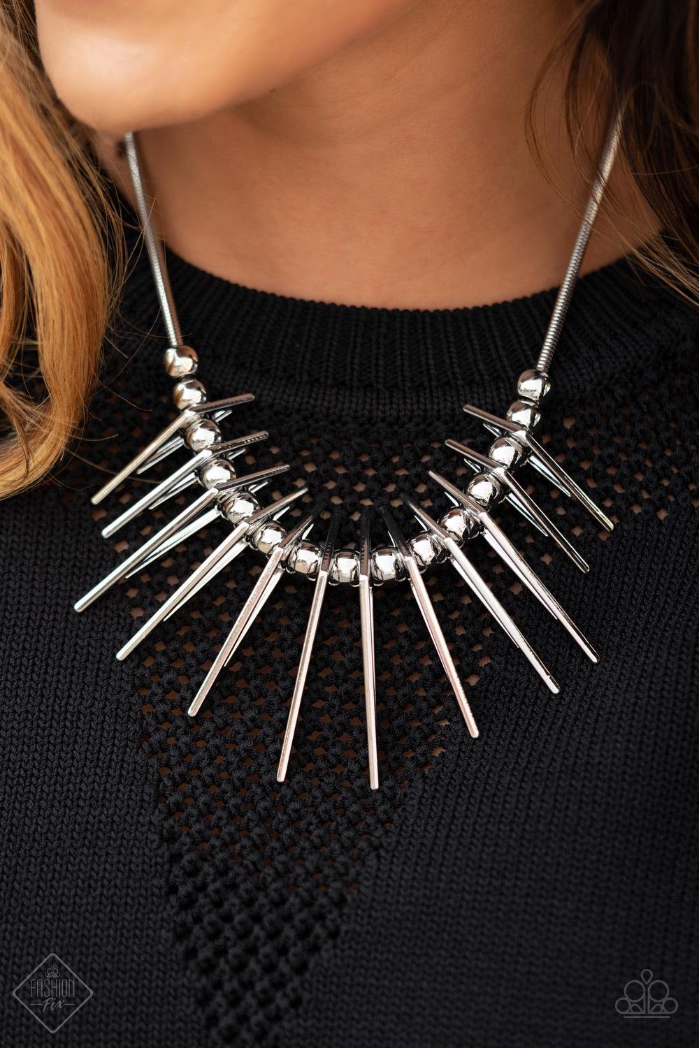 Paparazzi Accessories Fully Charged - Silver Separated by bold silver beads, triangular silver frames gradually increase in intensity as they slide along a rounded silver snake chain, creating an electric fringe below the collar. Features an adjustable cl