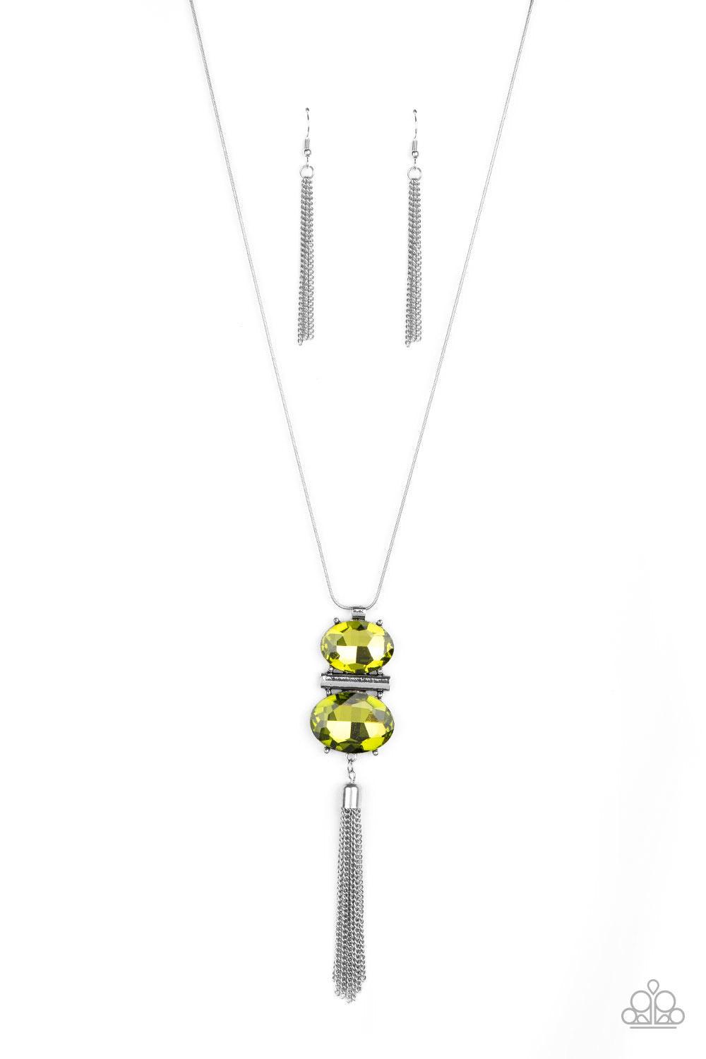 Paparazzi Accessories Runway Rival - Green A rectangular silver bar is nestled between two oversized oval green rhinestones, creating a stacked pendant at the bottom of a rounded silver snake chain. A shimmery silver chain tassel swings from the bottom, a