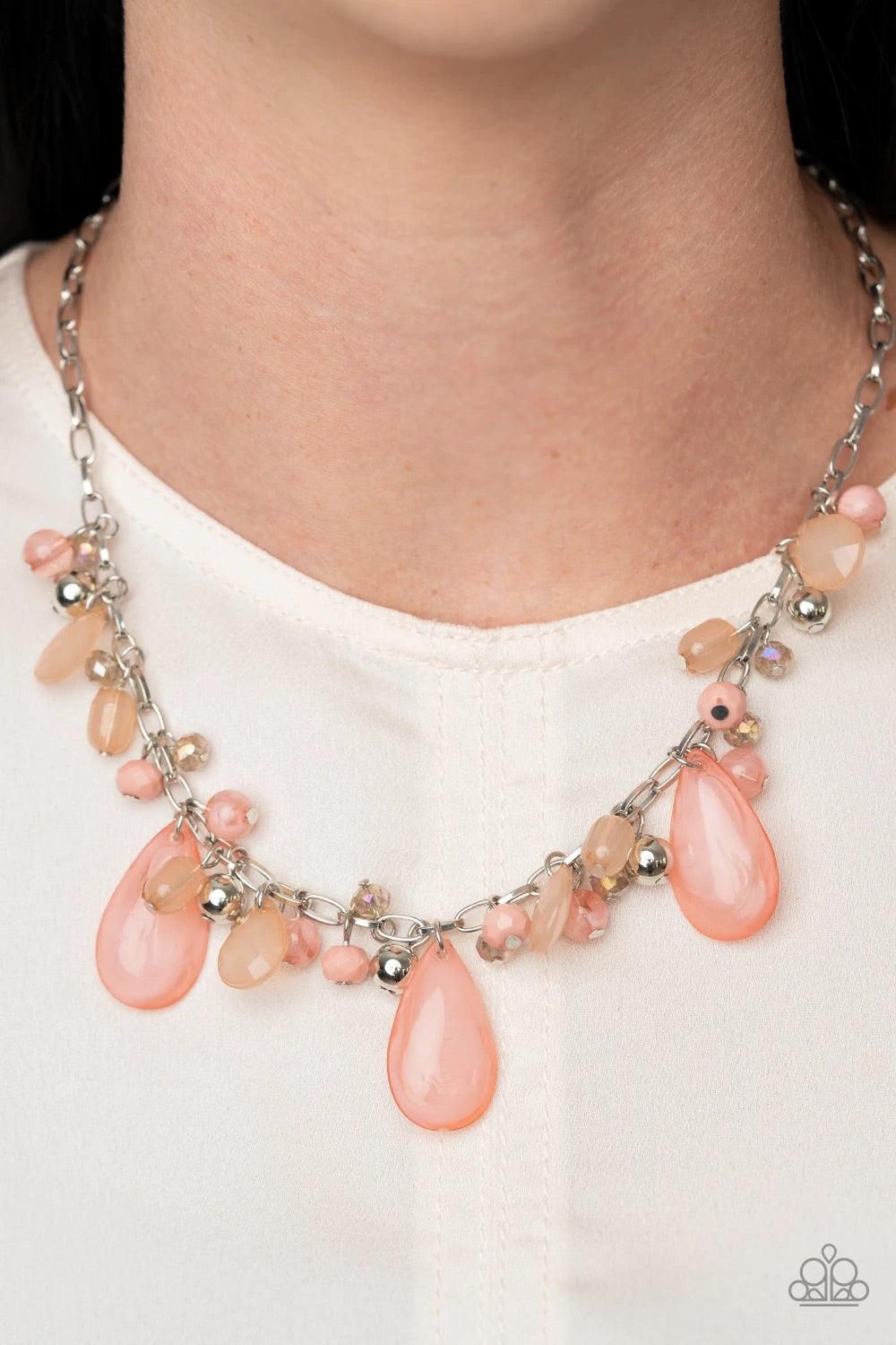 Paparazzi Accessories Seaside Solistice - Pink Featuring classic round and tranquil teardrop shapes, a glassy and opaque collection of Rose Tan, Peach Nougat, silver, and iridescent beads swing from a shimmery silver chain below the collar, creating an en