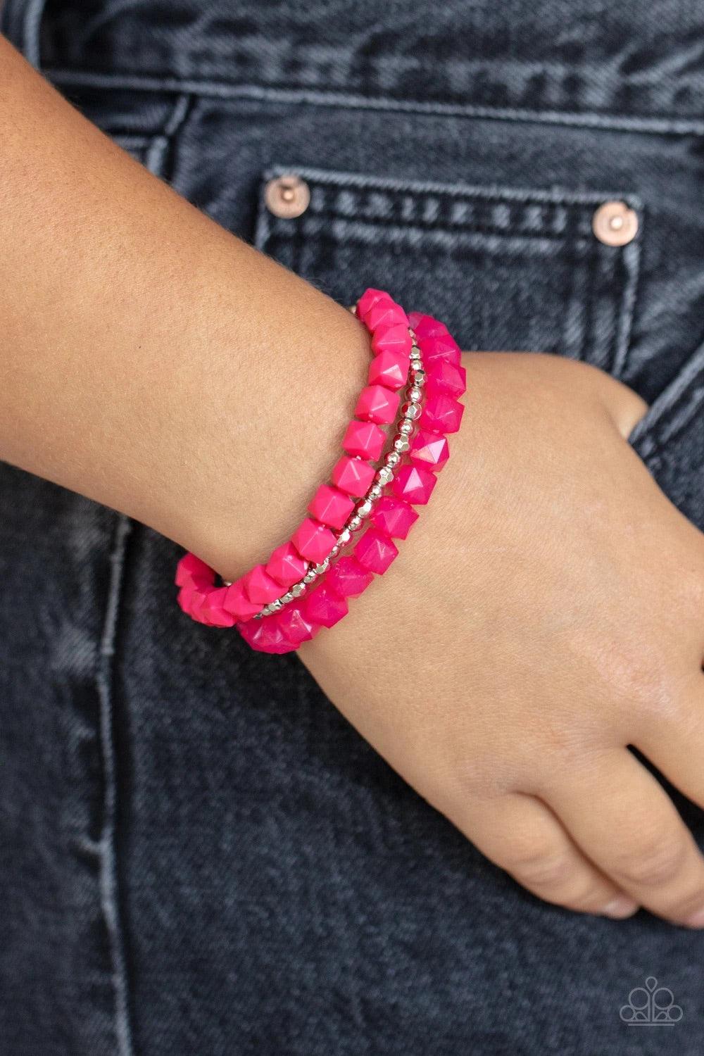 Paparazzi Accessories Vacay Vegabond - Pink Infused with a strand of round and faceted silver beads, faceted rows of solid and opaque pink cube beads are threaded along stretchy bands, wrapping around the wrist for a vivacious pop of color. Sold as one se