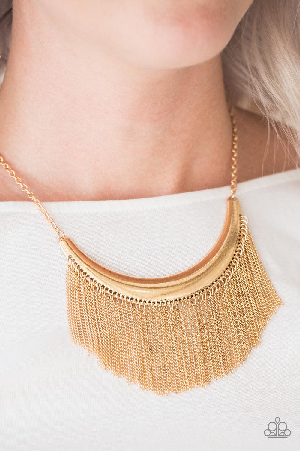 Paparazzi Accessories Zoo Zone - Gold Brushed in an antiqued finish, glistening gold chains stream from the bottom of a gold crescent, creating a bold fringe below the collar for a fierce look. Features an adjustable clasp closure. Sold as one individual