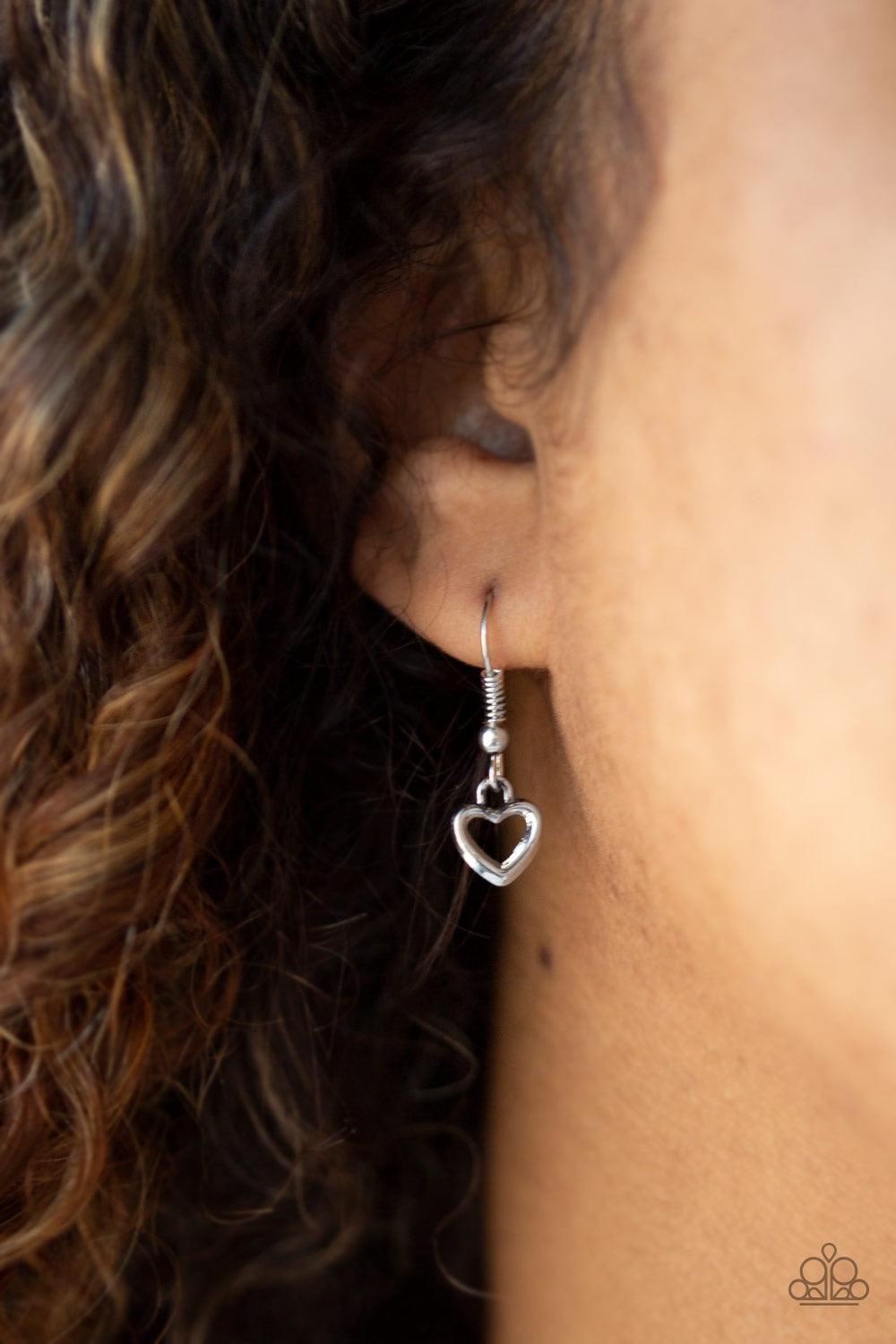Paparazzi Accessories Everything I Am - Blue A solitaire blue rhinestone, dainty silver heart, and a shimmery silver disc stamped with the inspirational phrase, "Everything I am, you helped me be", swings below the collar for a whimsical look. Features an