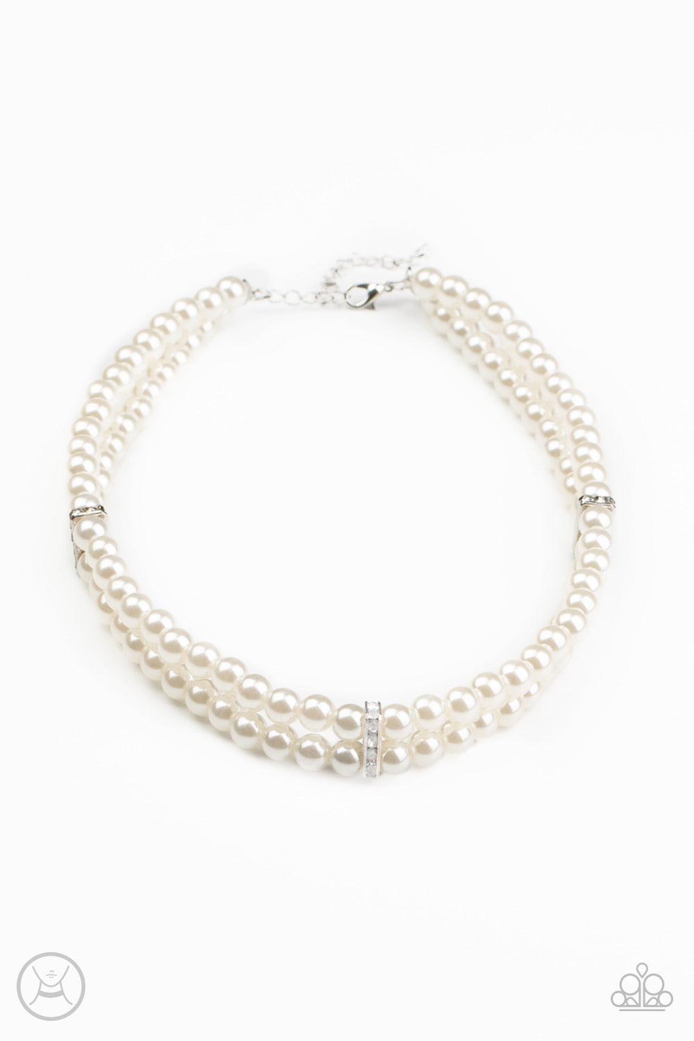Paparazzi Accessories Put On Your Party Dress - White Pinched between white rhinestone encrusted frames, strands of classic white pearls layer around the neck for a timeless look. Features an adjustable clasp closure. Sold as one individual choker necklac