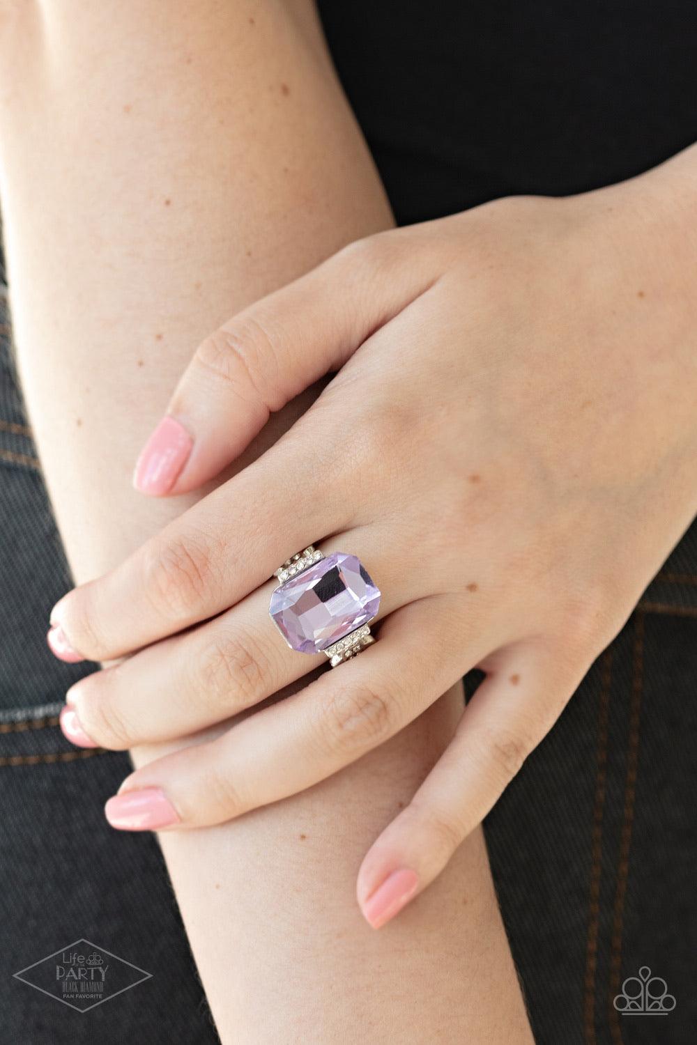 Paparazzi Accessories You Can COUNTESS On Me - Purple Featuring a regal emerald cut, a dramatically oversized purple rhinestone is flanked by dainty silver frames encrusted in glassy white rhinestones for a refined flair. Features a stretchy band for a fl