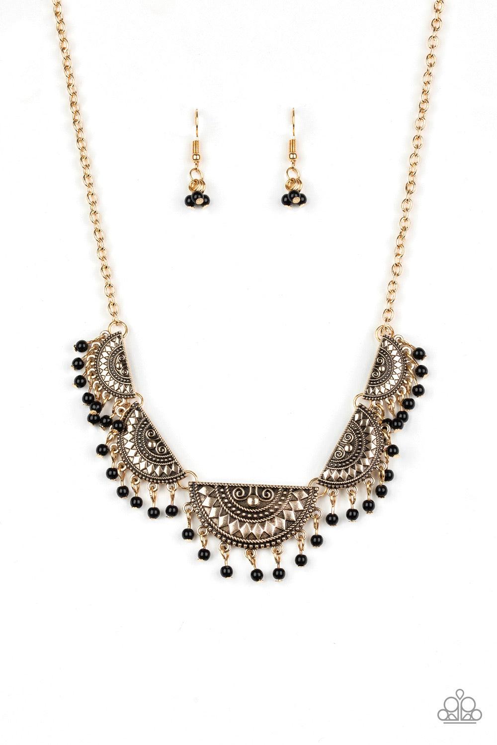 Paparazzi Accessories Boho Baby - Gold Embossed in tribal inspired patterns, gold half-moon frames link below the collar. Dainty black beads swing from the bottoms of the ornate frames, creating a flirtatious fringe. Features an adjustable clasp closure.