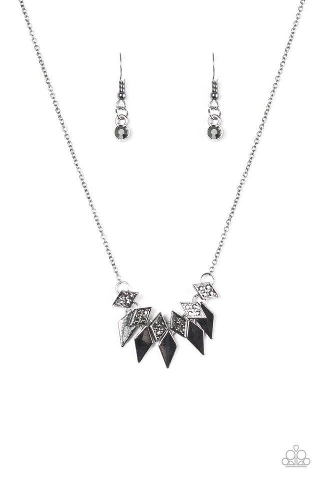 Paparazzi Accessories Over The Edge - Black Encrusted in glittery hematite rhinestones, dainty diamond-shaped frames give way to matching gunmetal frames, creating an edgy fringe below the collar. Features an adjustable clasp closure. Sold as one individu