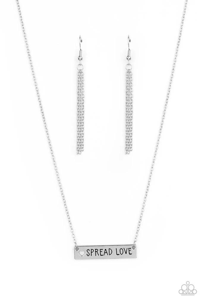 Paparazzi Accessories Spread Love - Silver Featuring a dainty heart cutout, a shiny silver plate is stamped in the phrase, "Spread Love," creating an inspirational phrase below the collar. Features an adjustable clasp closure. Sold as one individual neckl