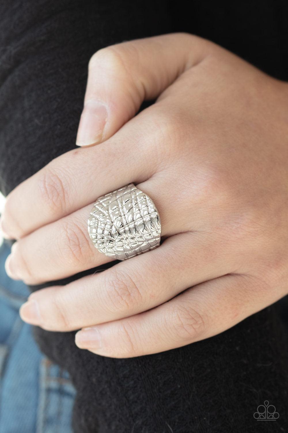 Paparazzi Accessories Metal Jungle - Silver Etched in an abstract linear pattern, a thick silver frame curls around the finger for an edgy metallic look. Features a stretchy band for a flexible fit. Jewelry