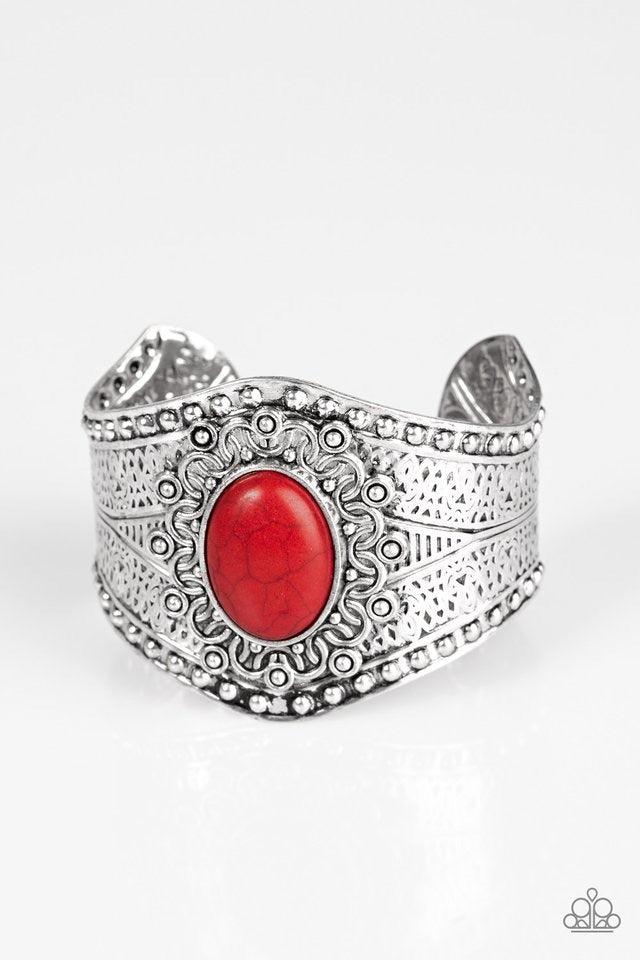 Paparazzi Accessories Majave Majesty - Red Delicately hammered and studded in tribal inspired textures, a thick silver cuff wraps around the wrist in an artisan inspired fashion. A smooth red stone is pressed into the middle of a silver sunburst pattern,