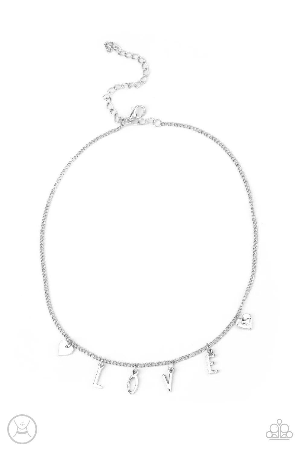 Paparazzi Accessories Love Conquers All - Silver Nestled between a pair of dainty silver hearts, dangling silver letter charms spell out the word, "LOVE," creating a flirty fringe around the neck. Features an adjustable clasp closure. Sold as one individu