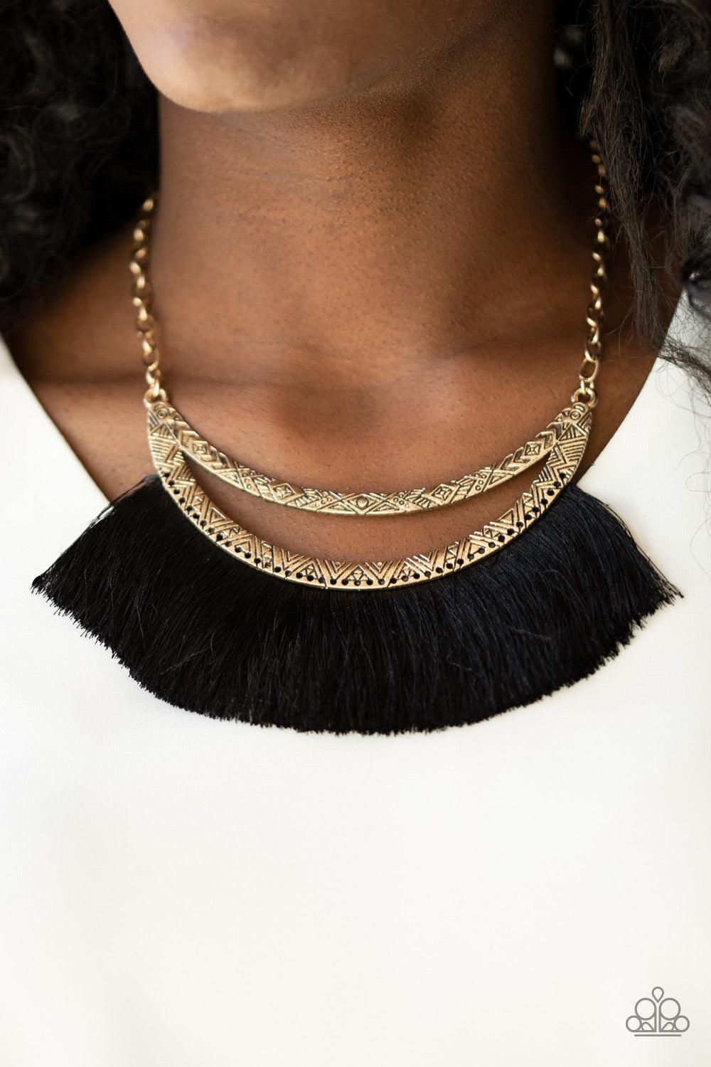 Paparazzi Accessories The MANE Event - Gold A plume of shiny black thread flares out from the bottom of an airy half-moon frame stamped in tribal inspired patterns, creating a bold fringe below the collar. Features an adjustable clasp closure. Jewelry