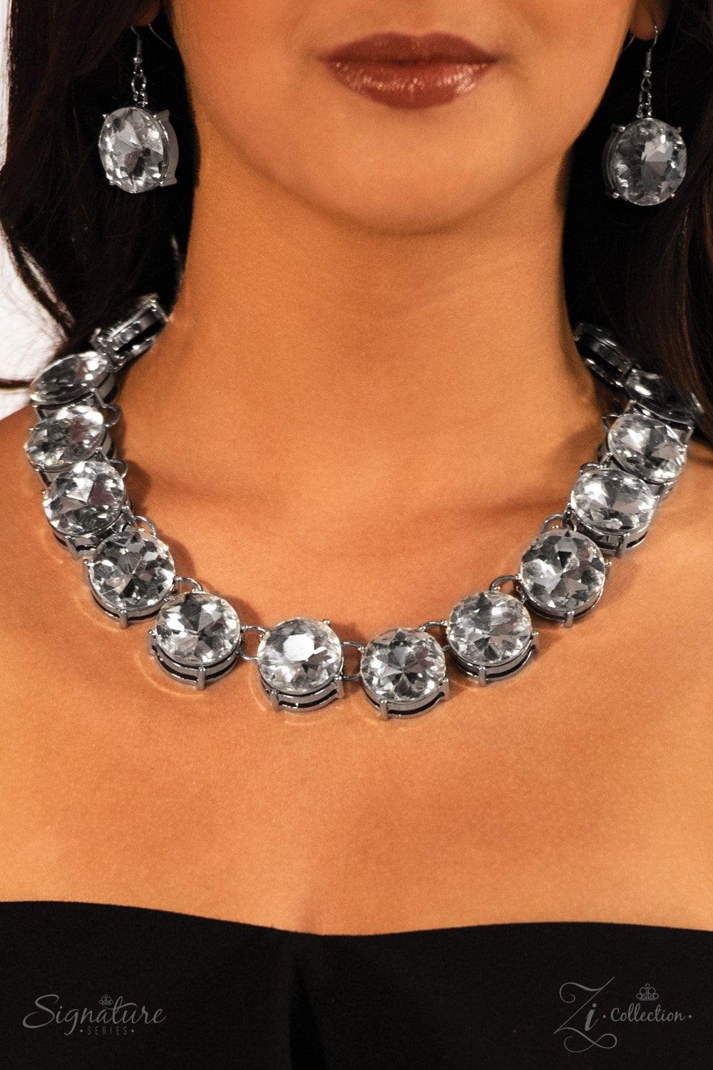 Paparazzi Accessories The Marissa Dramatically oversized rhinestones drip from the collar, bringing a modern twist to a classic concept. The quarter-sized rhinestones brilliantly catch and reflect the light, creating blinding sparkle that will leave a las