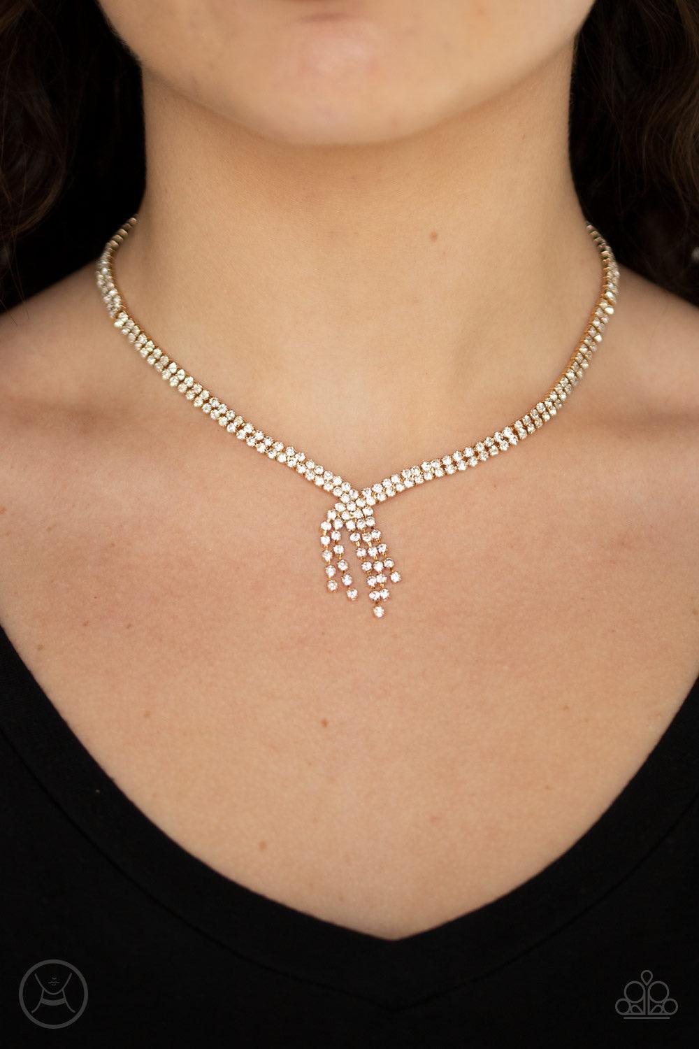 Paparazzi Accessories Ante Up - Gold Featuring sleek gold fittings, two strands of glittery white rhinestones join into a sparkling chain below the collar. Chains flow in from both sides at varying lengths creating a glamorously asymmetrical pendant. Feat